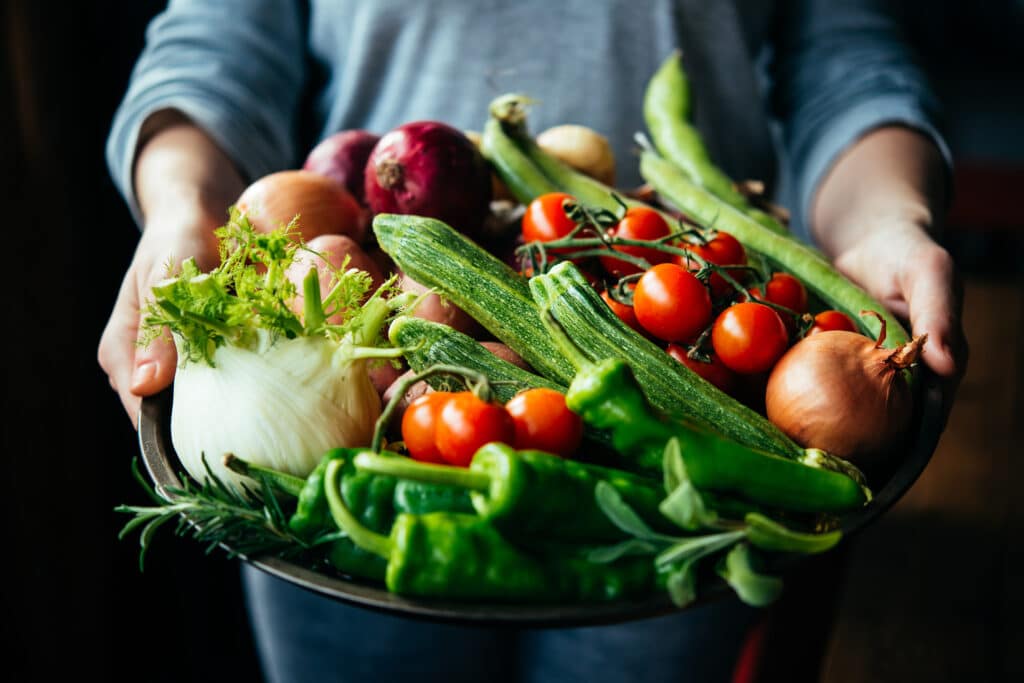 Handsholdingbigplatewithdifferentfreshfarmvegetables Autumn